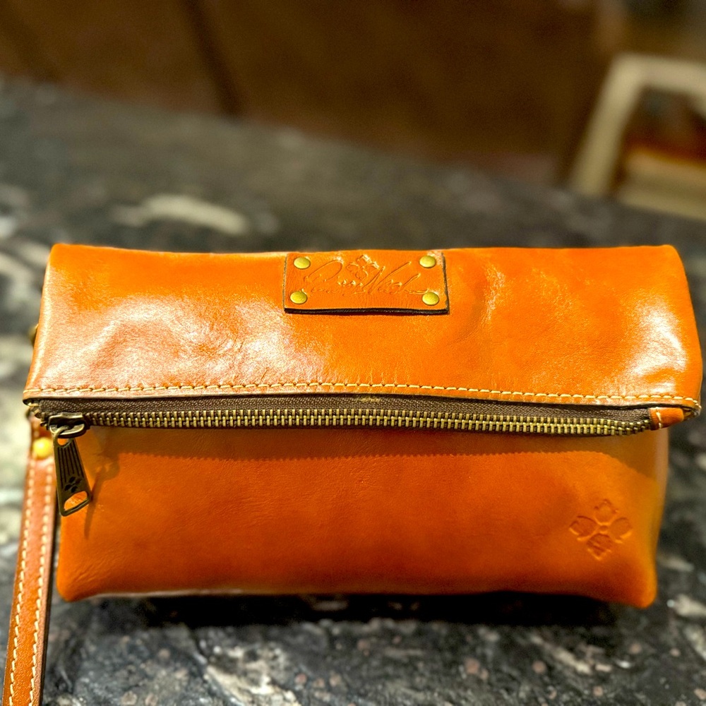 Magnetic style zip clutch bag. Never used, new with tag.